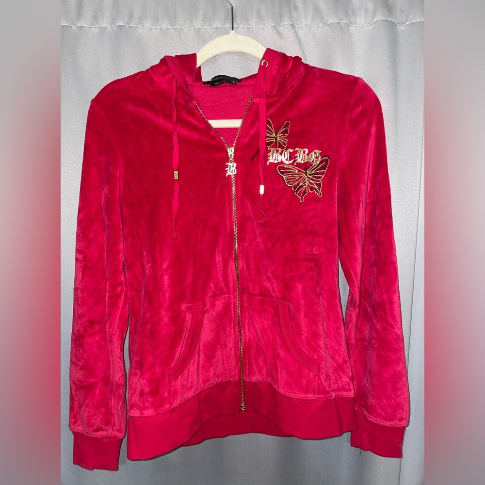 BCBG MaxAzria Red Hoodie with gold and black design.